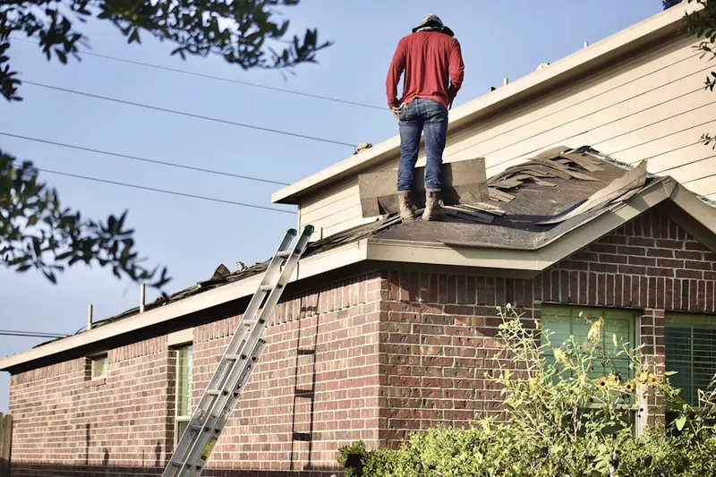 Professional roofer working on a residential roof in North Druid Woods